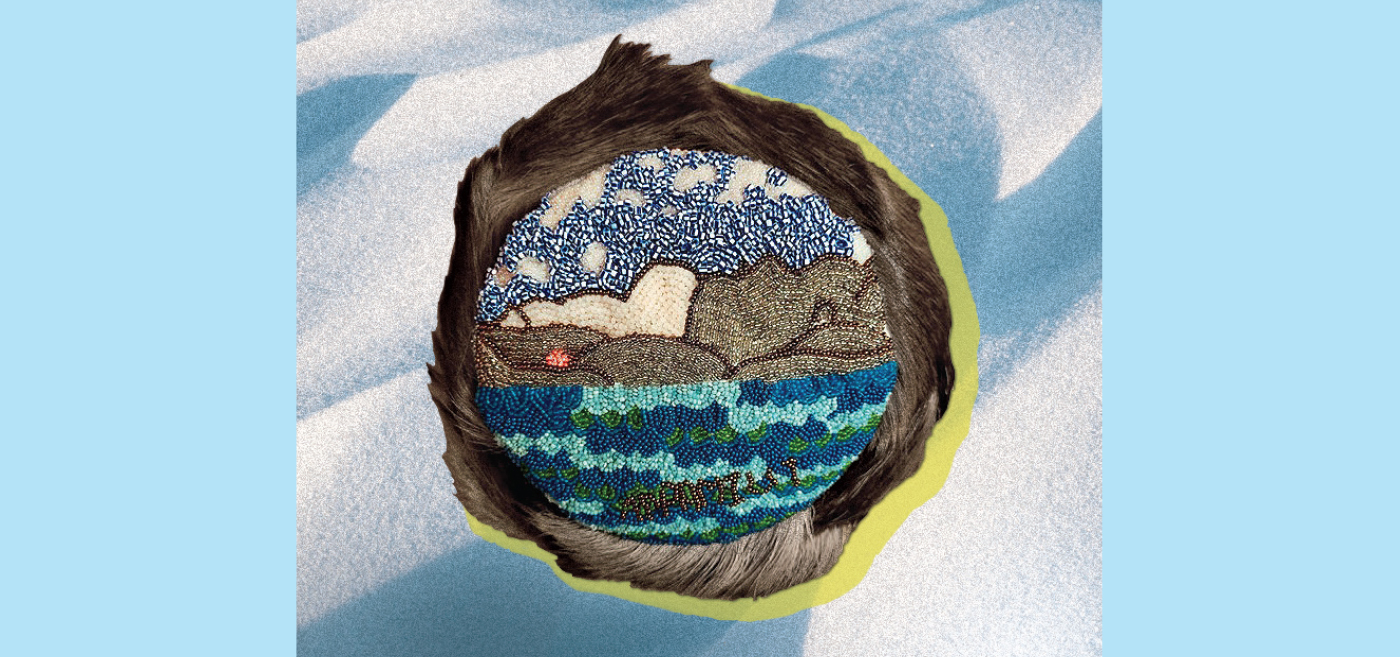 An intricate beadwork of vibrant blues, brown and green depicts an Arctic shoreline, stretching from the sky down to icy hills and out to the sea, wrapped within a round border of caribou hair.