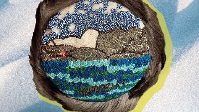 An intricate beadwork of vibrant blues, brown and green depicts an Arctic shoreline, stretching from the sky down to icy hills and out to the sea, wrapped within a round border of caribou hair.