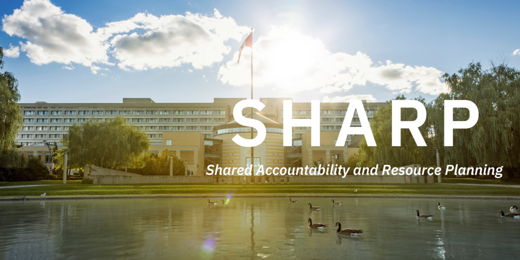 Landscape photo of exterior of Vari Hall on Keele Campus with SHARP acronym for Shared Accountability and Resource Planning.