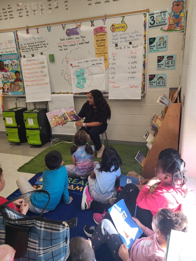 Year 2 Bachelor of Education student Chloe Furtado reading to a grade 4 class at St. Philip Elementary School
