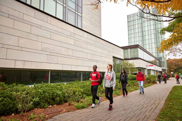 students walking by a building