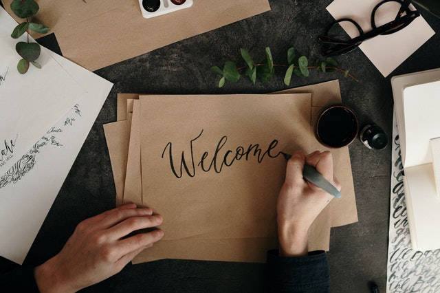writing welcome on brown paper with a marker