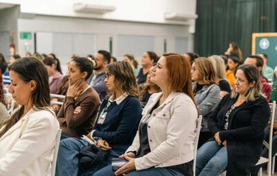 a photo of people listening to a speaker at a conference