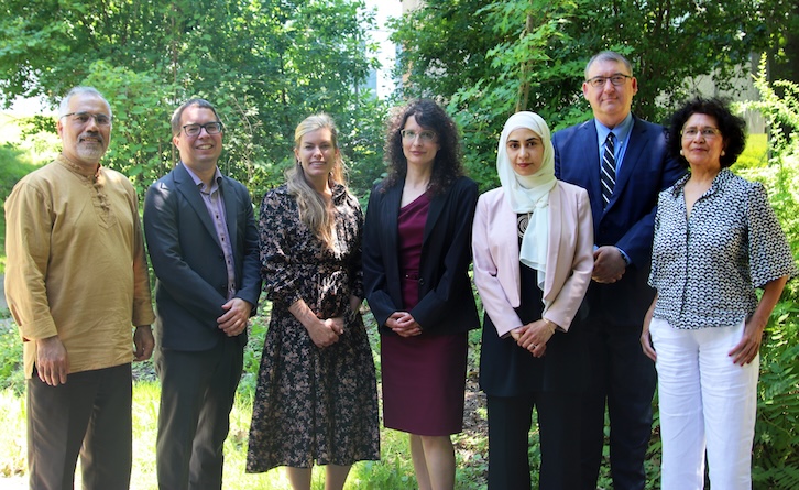 a photo of from left to right the names are as follows: Dr. Ali Asgary, Dr. Eric Kennedy, Dr. Jennifer Spinney (Area Coordinator), Dr. Evalyna Bogdan, Dr. Aaida Mamuji (Graduate Program Director), Dr. Jack Rozdilsky, Dr. Nirupama Agrawal