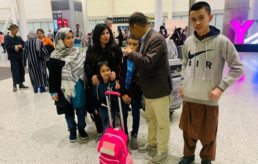 photo of Robina Aryubwal and her family at an airport