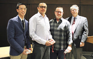 Dr. Raymond Mar, pictured left, standing beside three faculty members
