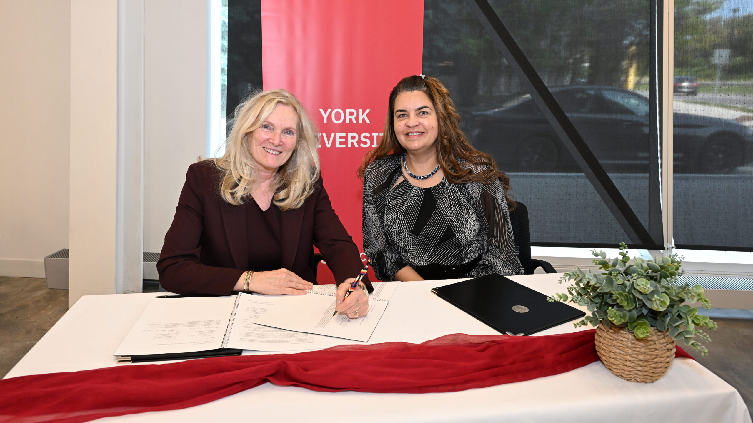 York University President and Vice-Chancellor Rhonda Lenton (left) and IPHCC, Chief Executive Officer and York Alumna Caroline Lidstone-Jones sign a relationship agreement