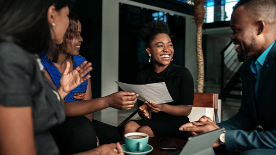 black female students presents her work to other students during a business meeting