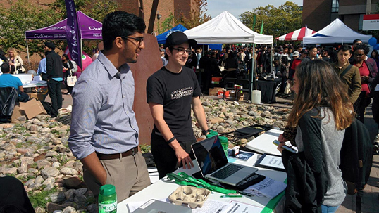 group of students around a stall
