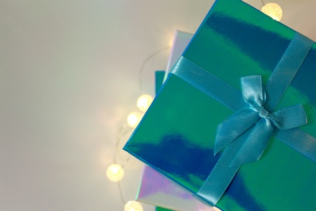 Two green and blue colored gift boxes laying on each other 