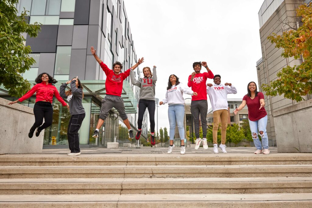 Students jumping and raising their hands