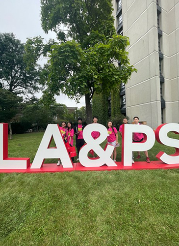 college students behind LA&PS sign