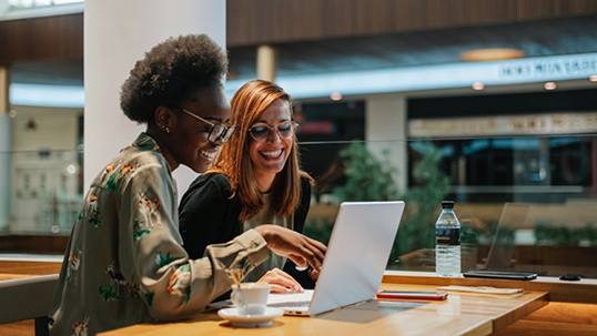 female student with advisor in from of the laptop