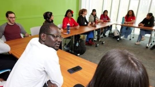 students sitting on table talking