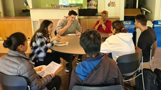 students having pizza with professors