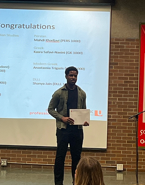 Abas Etokimo holding his certificate at the awards ceremony