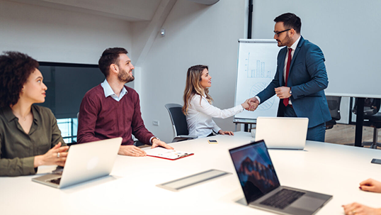 four people in a business meeting