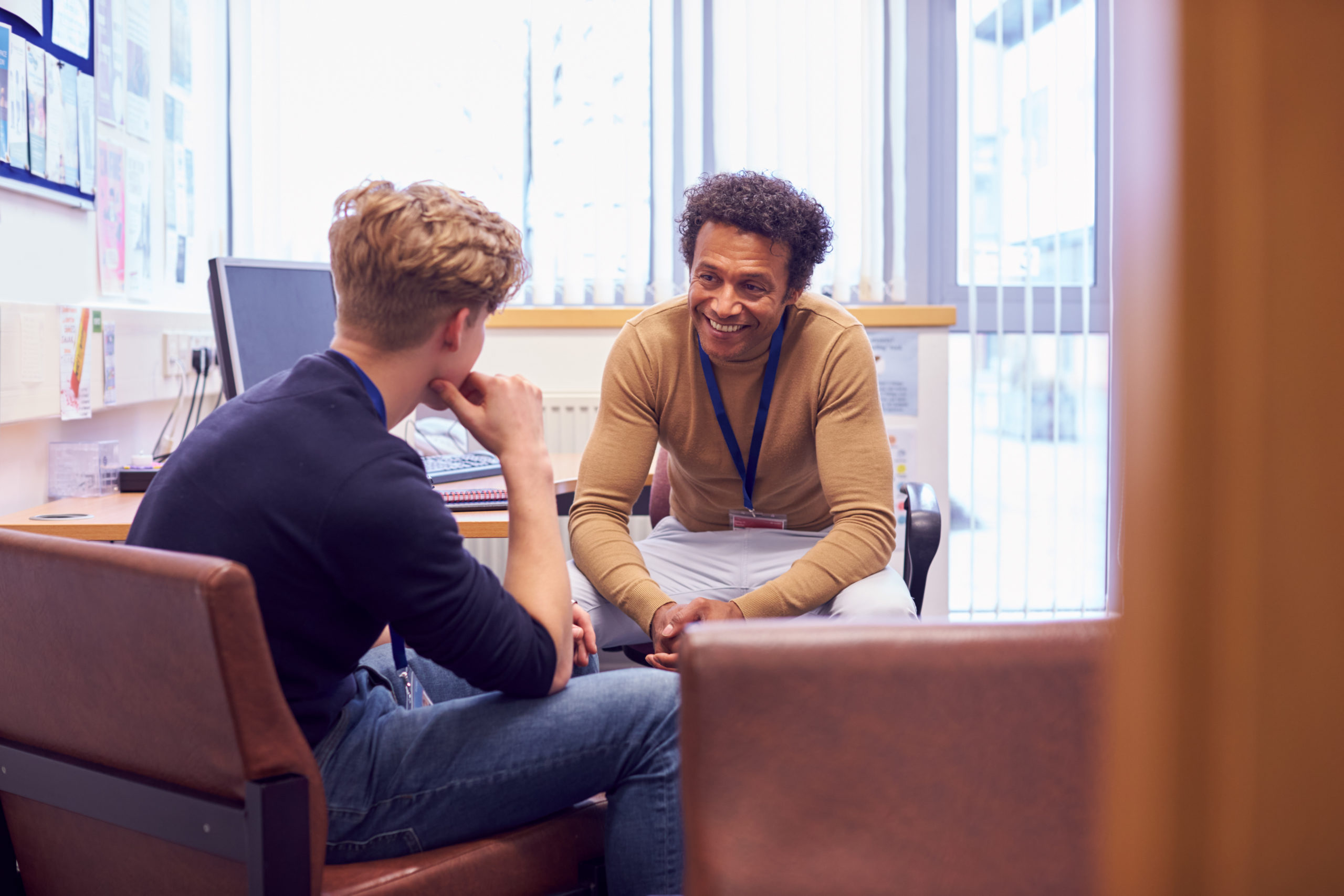 Student speaking with friendly academic advisor