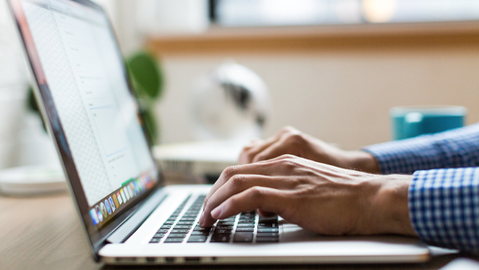 close up of person typing on laptop