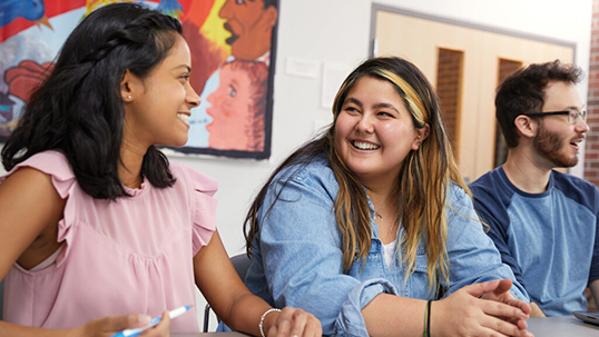 students smiling in a classroom