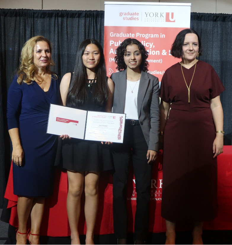 Picture of 2nd prize High School Essay Contest winner accepting award on stage