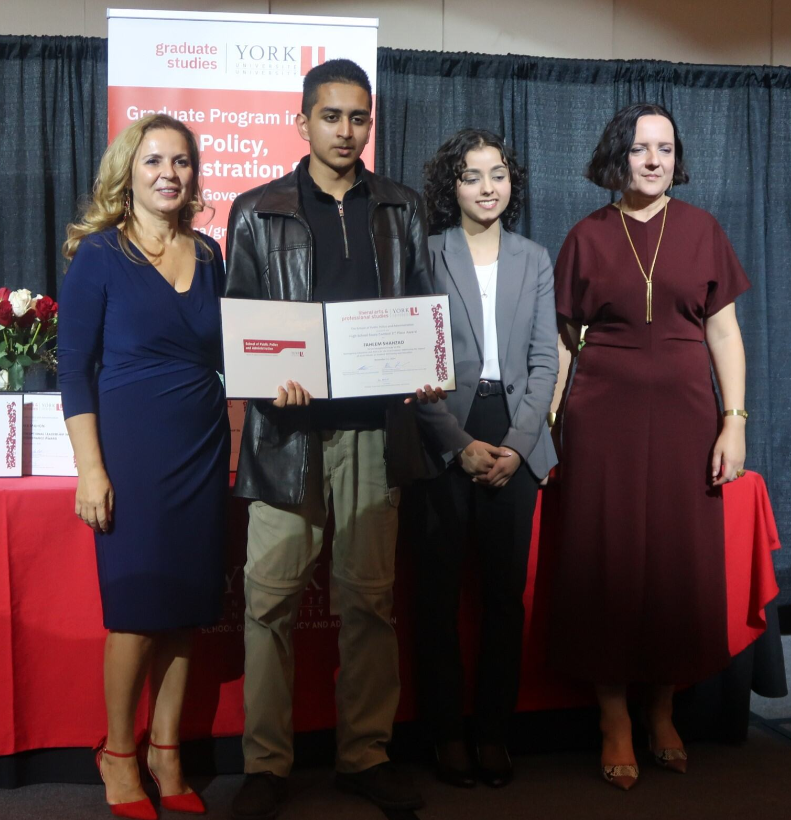 Picture of 3rd prize High School Essay Contest winner accepting award on stage