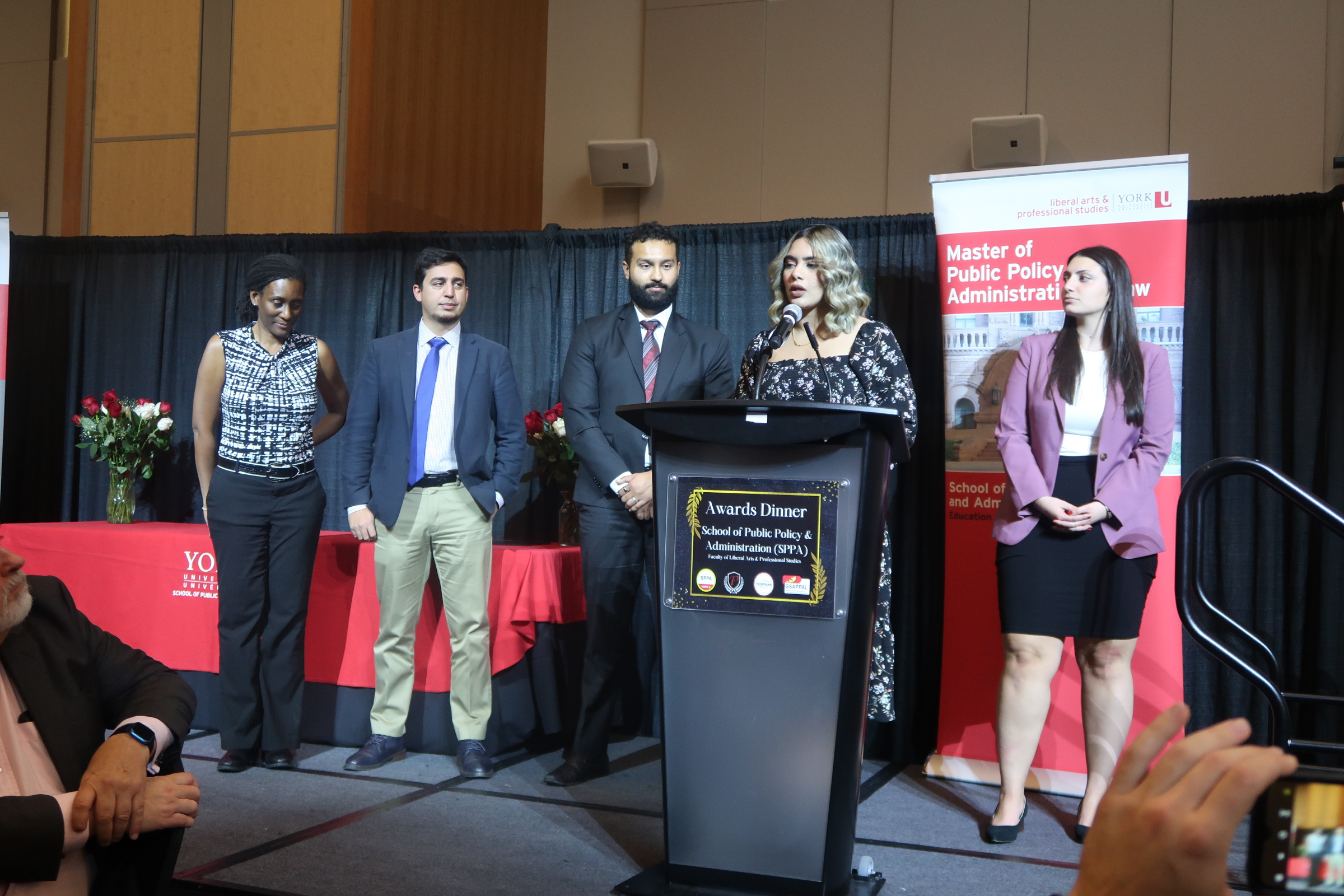 Students speak on stage at the recognition awards dinner.