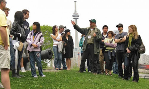 professor leading students on field trip to fort york in toronto