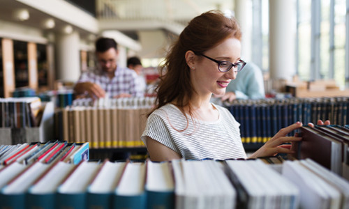 focus on woman browsing library books