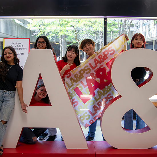 Students posing with LA&PS letters and LA&PS flag.
