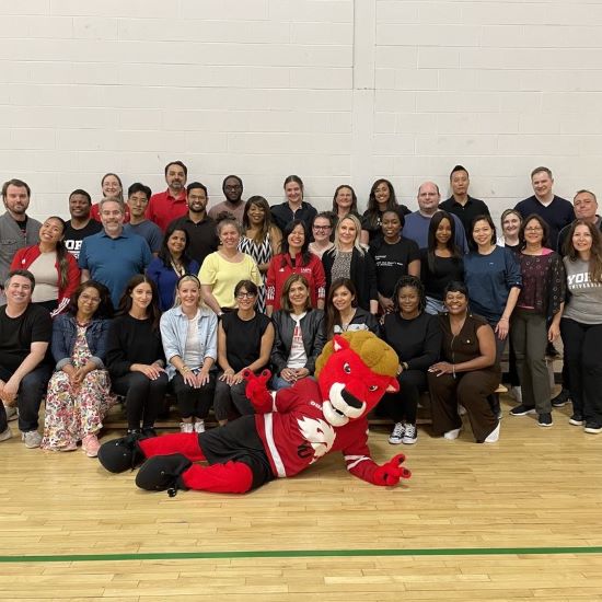 All LA&PS Managers posing for a photo with Yeo the Lion.