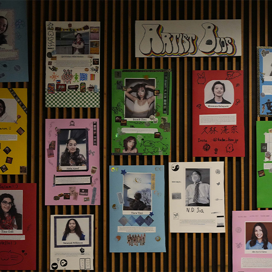 Collage posters with artist headshots and bios displayed on a wall.