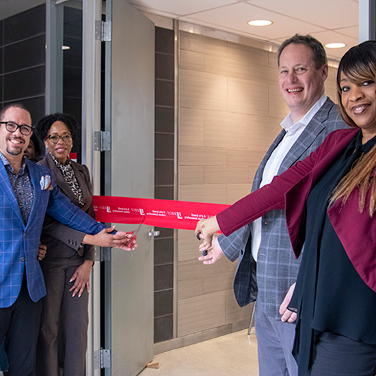 Faculty and staff members cutting the ribbon for the new black student lounge.