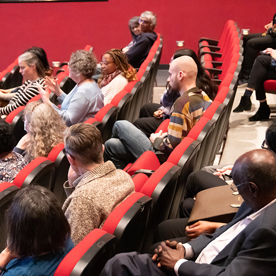 Lecture attendees sitting in a lecture hall.