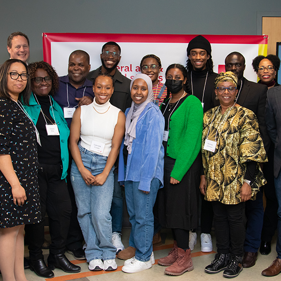 Tom Janes scholars posing with staff and faculty members.