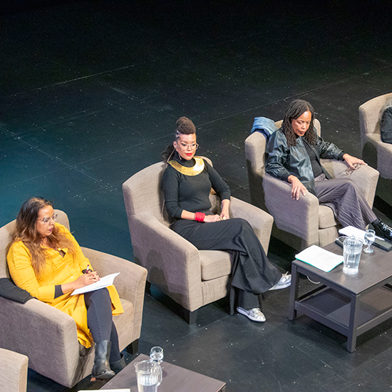 Panelists sitting on stage.