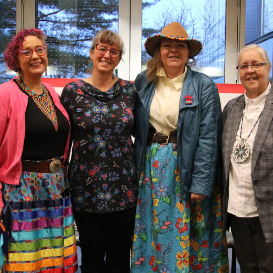 Four people posing together for a photo.