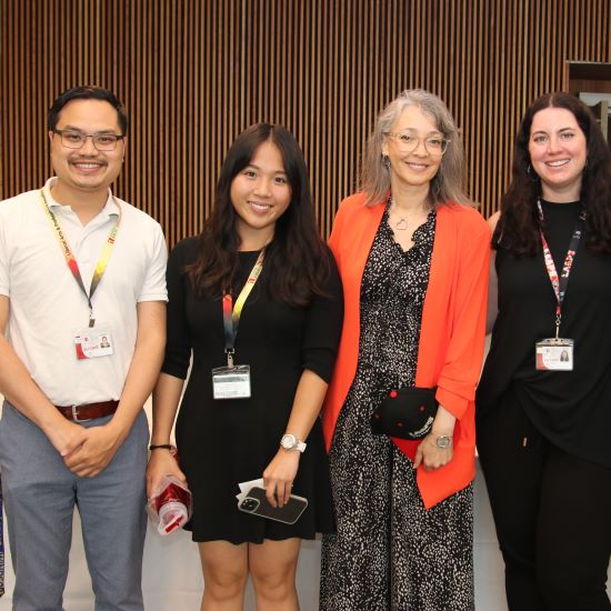 Staff members posing for a picture together.