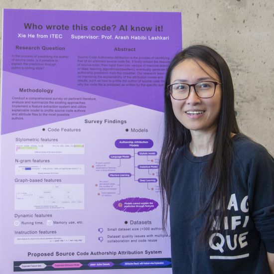 Student posing in front of her poster project.