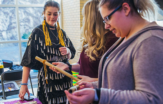 Students browsing Indigenous crafts at a table on York U's Keele campus.