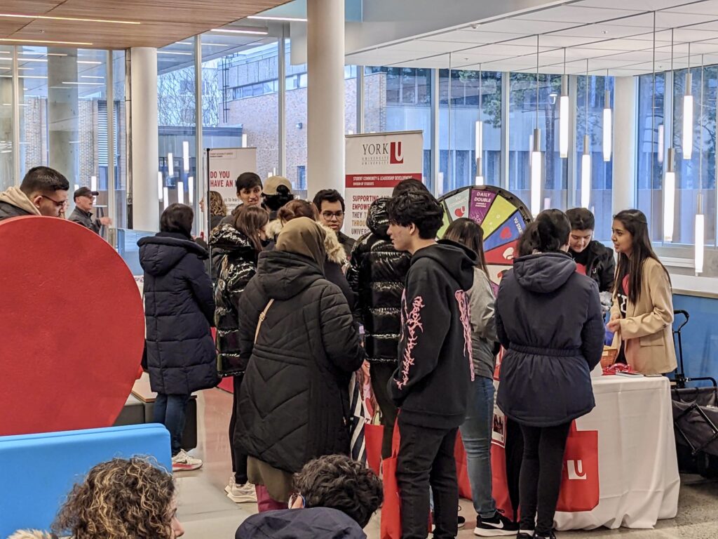 Students bustling about at a York Campus Fair.