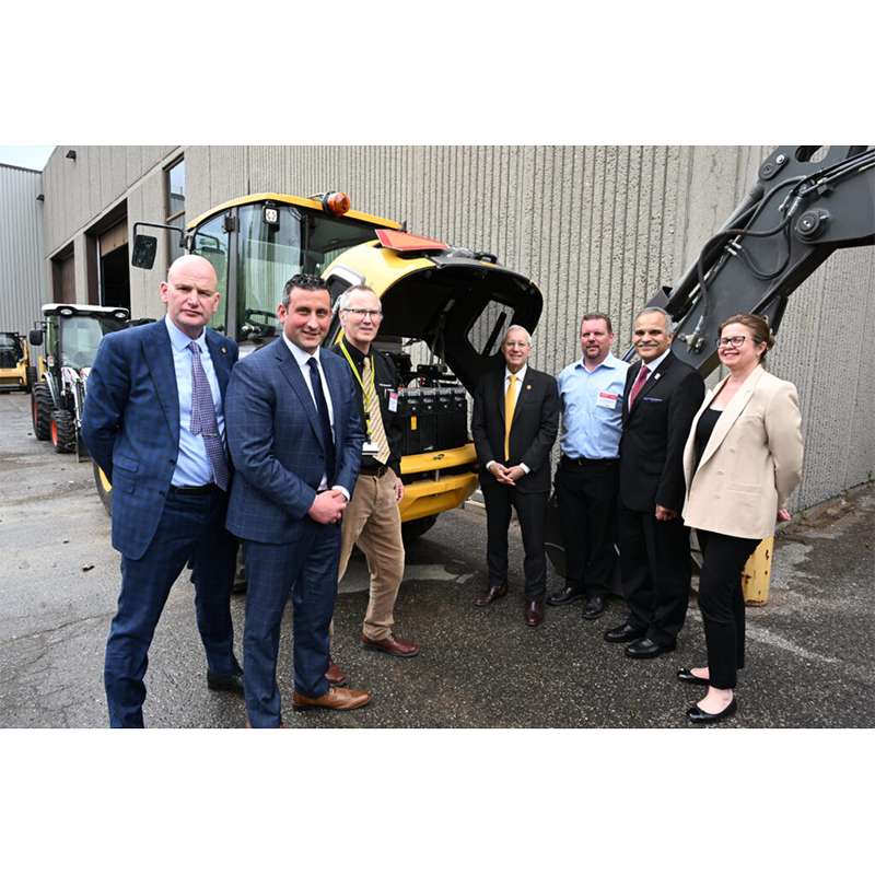 Group of York representatives standing in front of construction machinery.