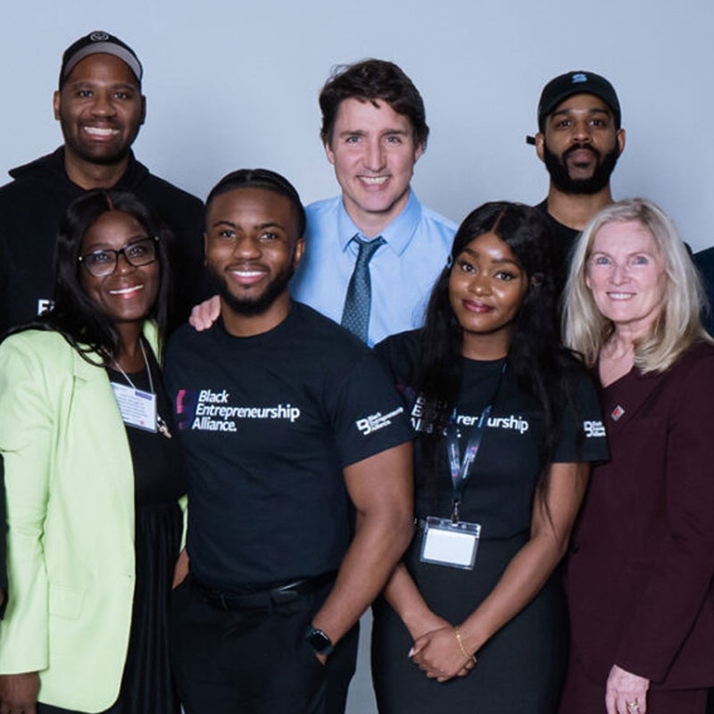 President Rhonda Lenton with Prime Minister Justin Trudeau and a group of students.