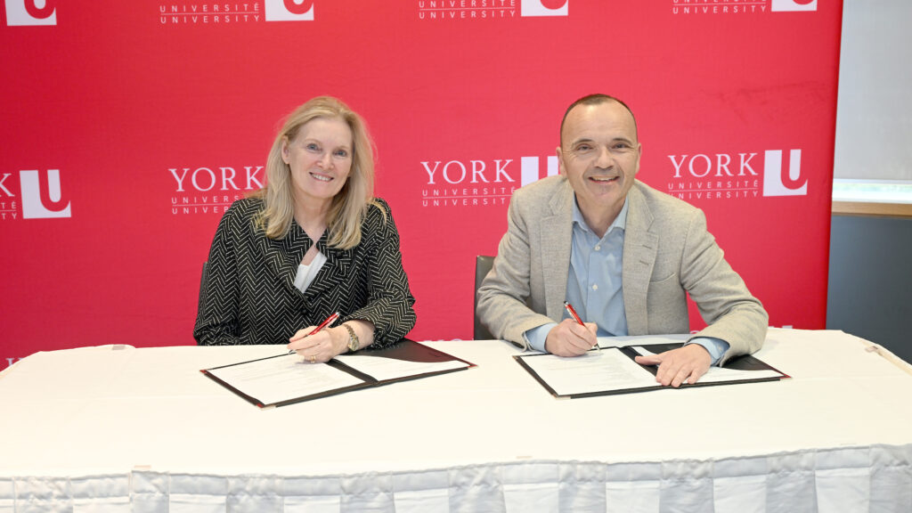 President Rhonda Lenton at a table with an industry partner.