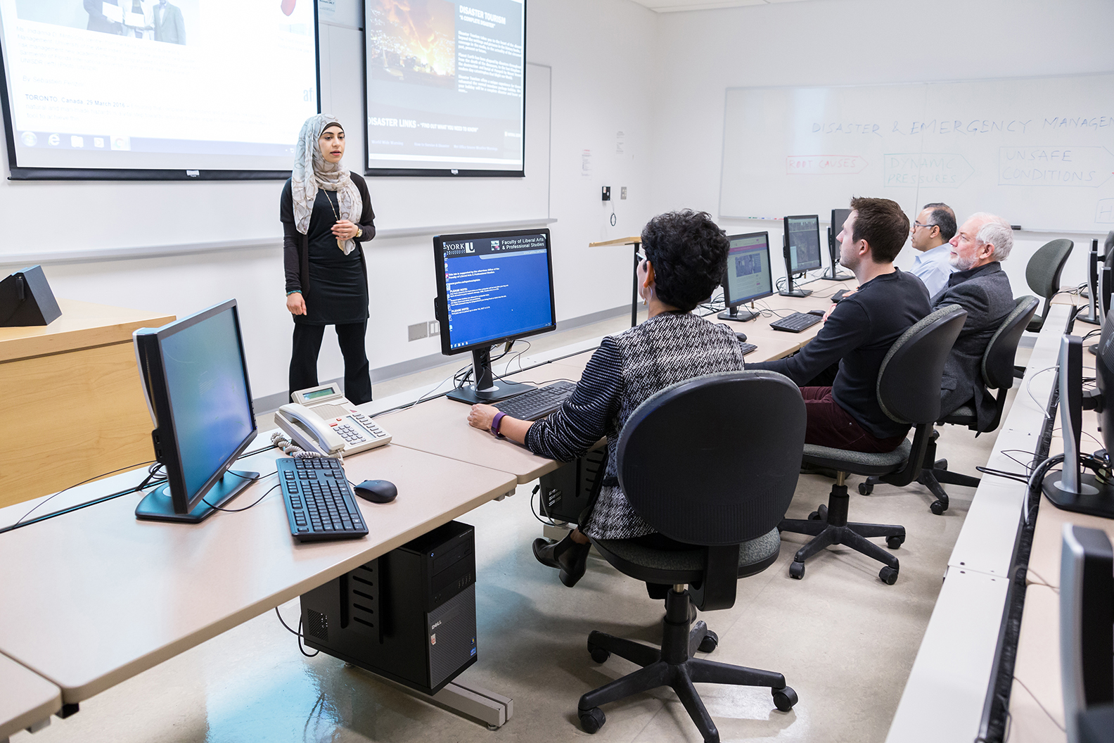 A person presenting in front of people.