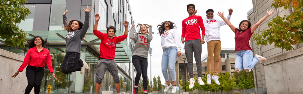 students jumping in front of the Life Sciences Building
