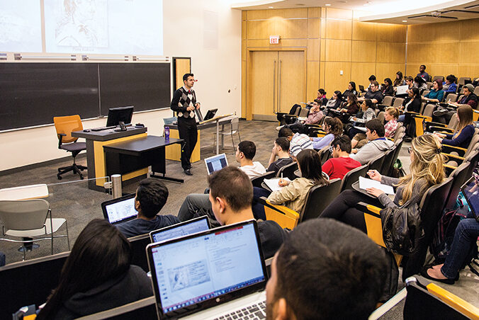 students in a classroom on laptops 