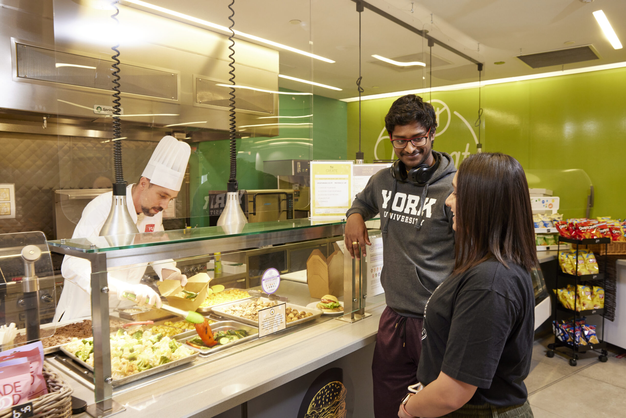 Students standing at a food counter