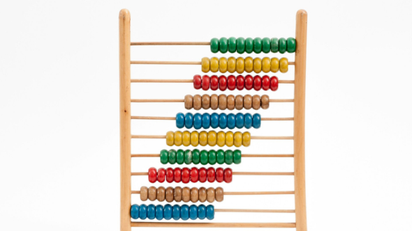 A wooden bead maze with various colours on a white background