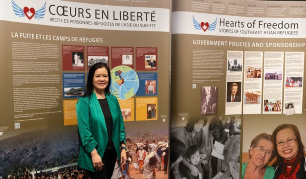 Stephanie Phetsamay Stobbe in front of part of the Hearts of Freedom exhibit.